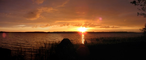 Sunset Sun still visible over the horizon at eleven at night in Finland