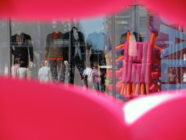Reflection of an inflatable suit in a department store window
