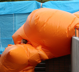 Big Blob inflatable suit descending a flight of stairs