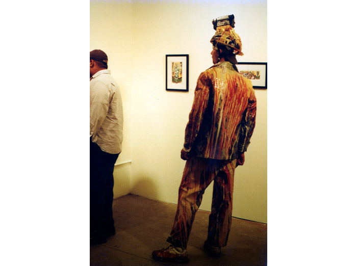 Jimmy Kuehnle browsing art while wearing a head cam and rubber suit