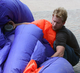 Jimmy Kuehnle inflating the inflatable suit titled Walking Fish in San Antonio, Texas