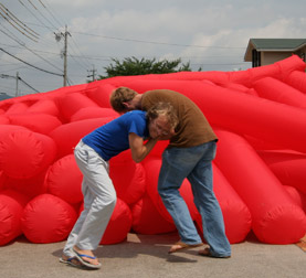 Kjell Hahn and Jimmy Kuehnle take a break from testing a new inflatable installation