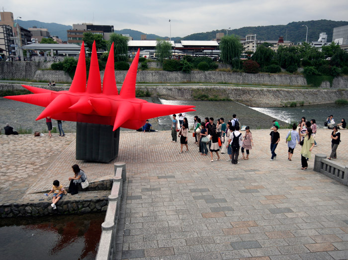 Big Red inflatable suit along the Kamo River in Kyoto, Japan